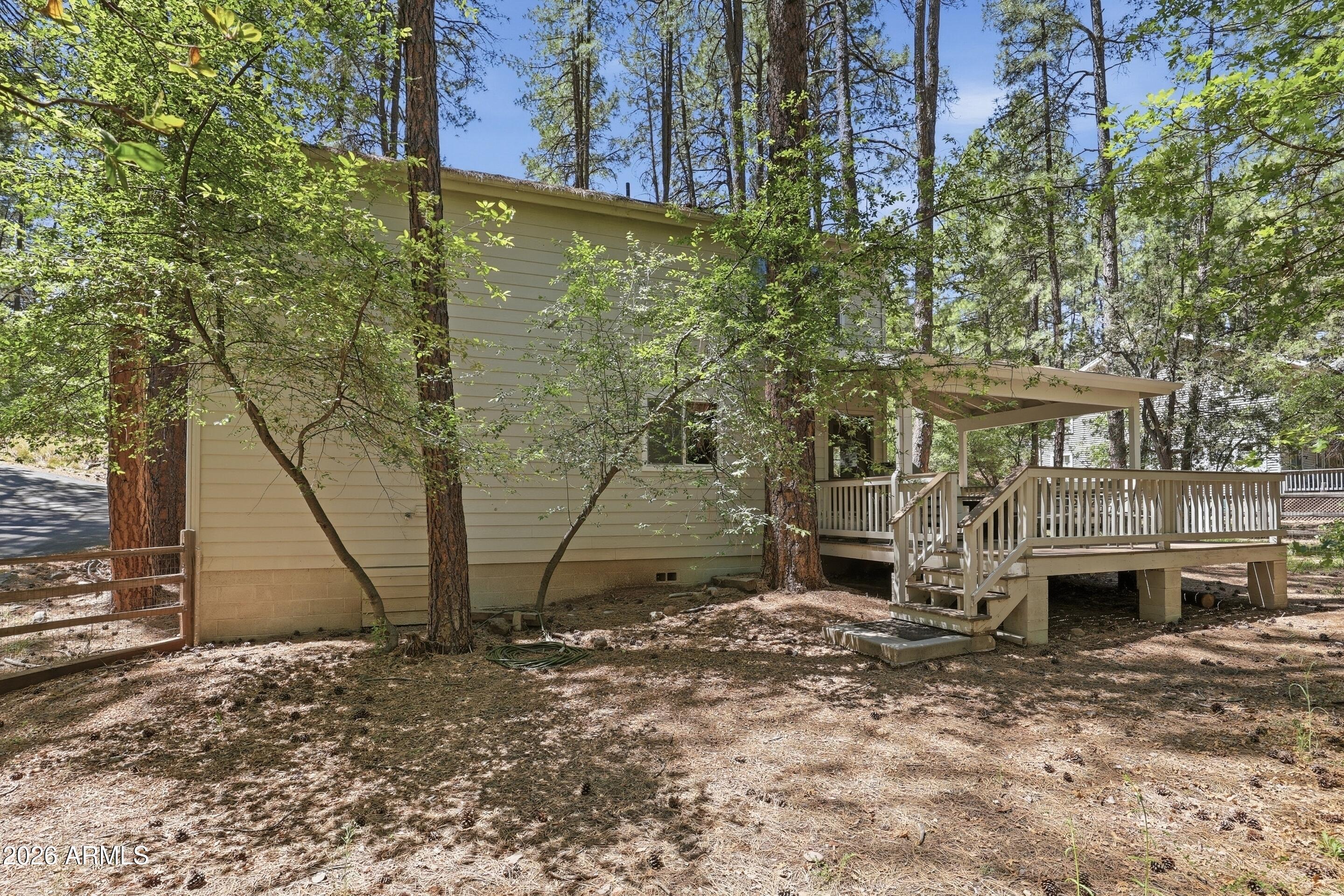 6322 Sharyn Road Pine, AZ 85544 - Photo 28 of 37 a view of a brick house with a yard