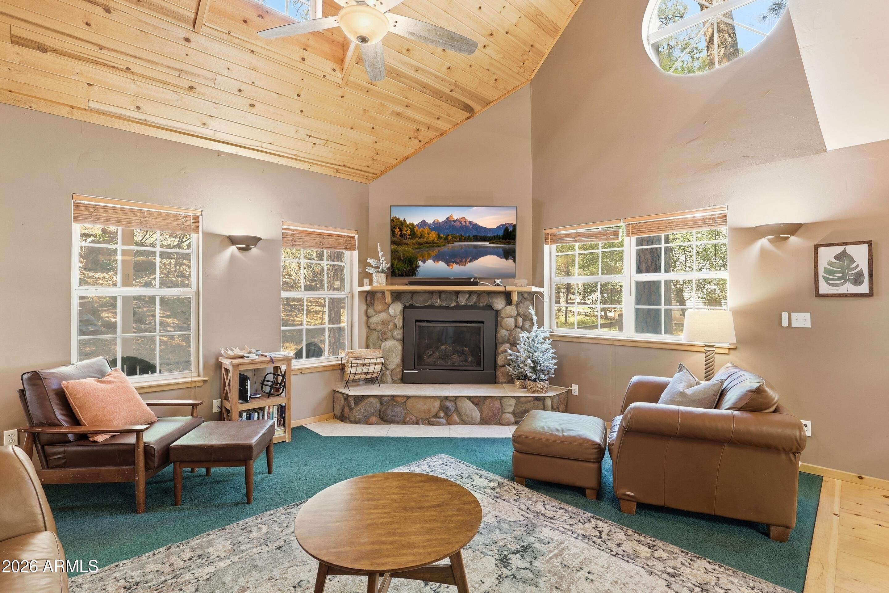 6322 Sharyn Road Pine, AZ 85544 - Photo 7 of 37 a living room with furniture a rug and a fireplace