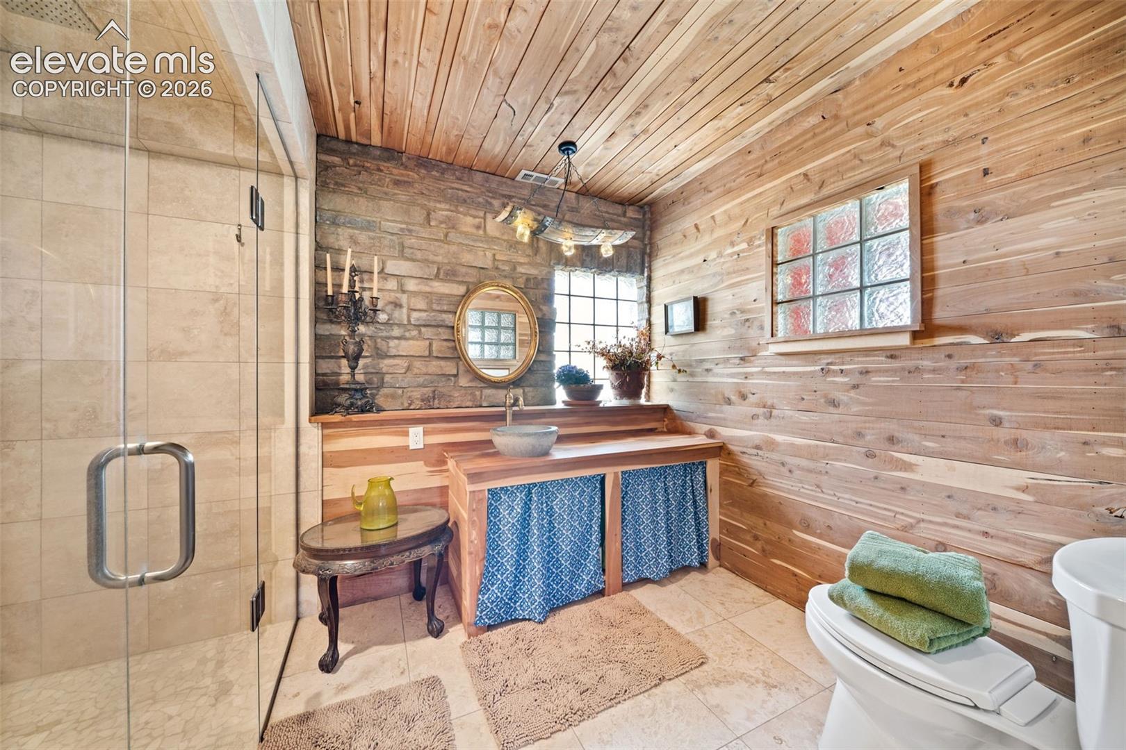 351 High Pasture Road Florissant, CO 80816 - Photo 20 of 42 Beautiful primary en-suite featuring a walk-in tile shower.