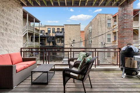 a view of a chairs and table in the balcony