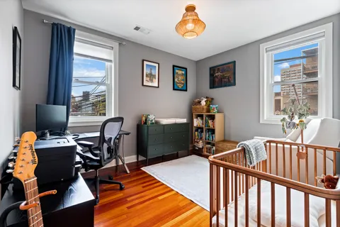 a bedroom with furniture and a book shelf