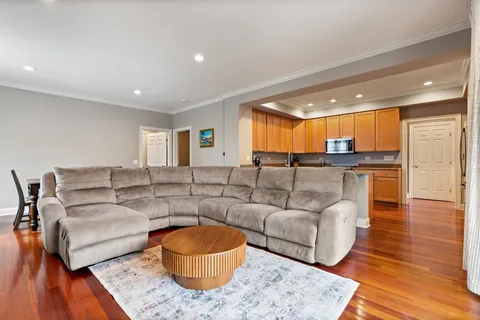 a living room with furniture a flat screen tv and a large window