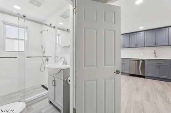 a bathroom with a sink a toilet and shower