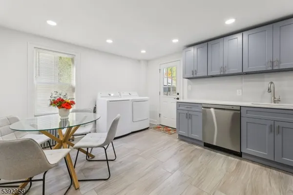 a kitchen with a sink cabinets and wooden floor