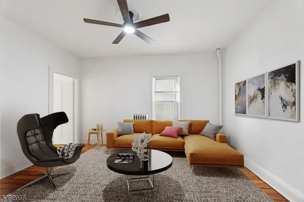 a living room with furniture a rug and a window