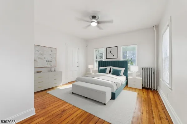 a spacious bedroom with a bed and a chandelier