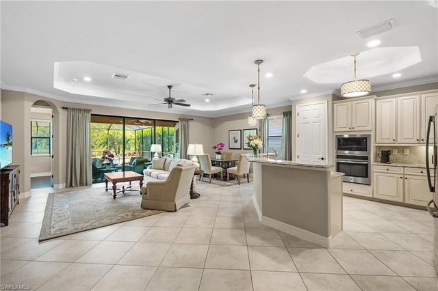a living room with furniture and kitchen view