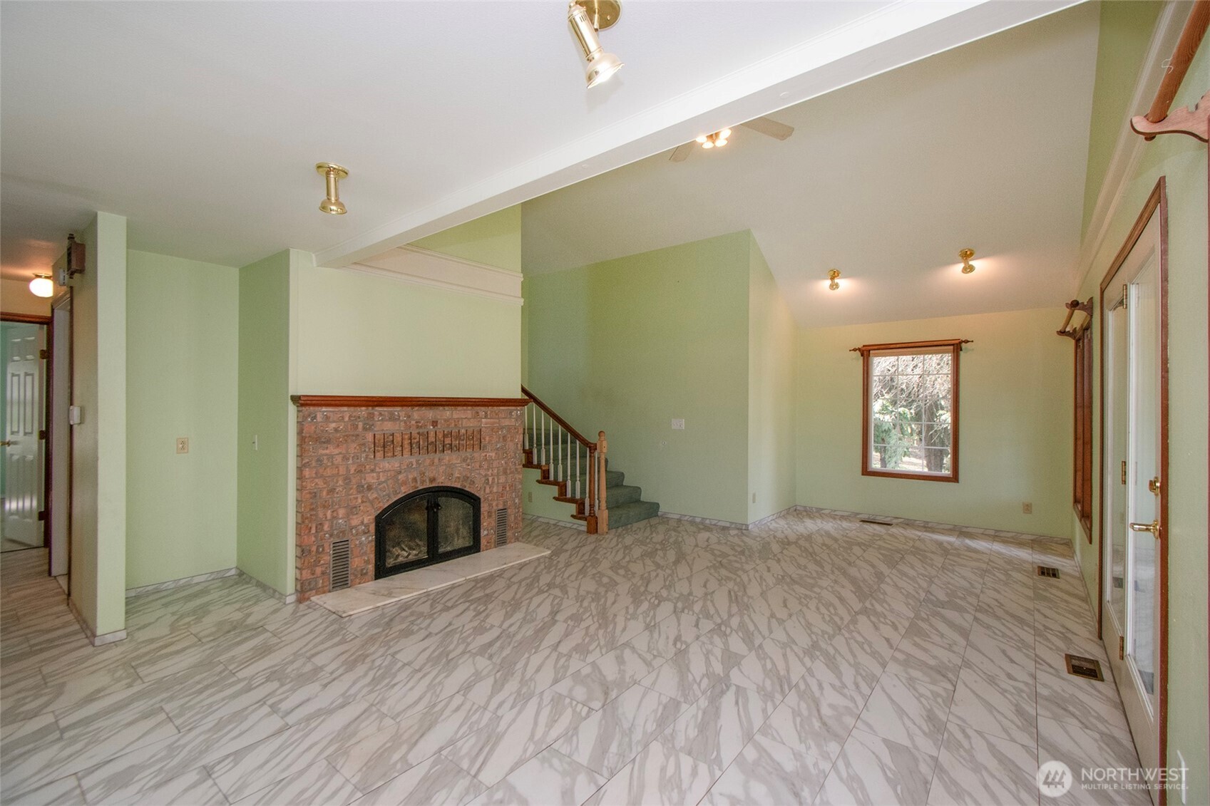 153 Spencer Road Sequim, WA 98382 - Photo 11 of 36 a view of empty room with fireplace and wooden floor