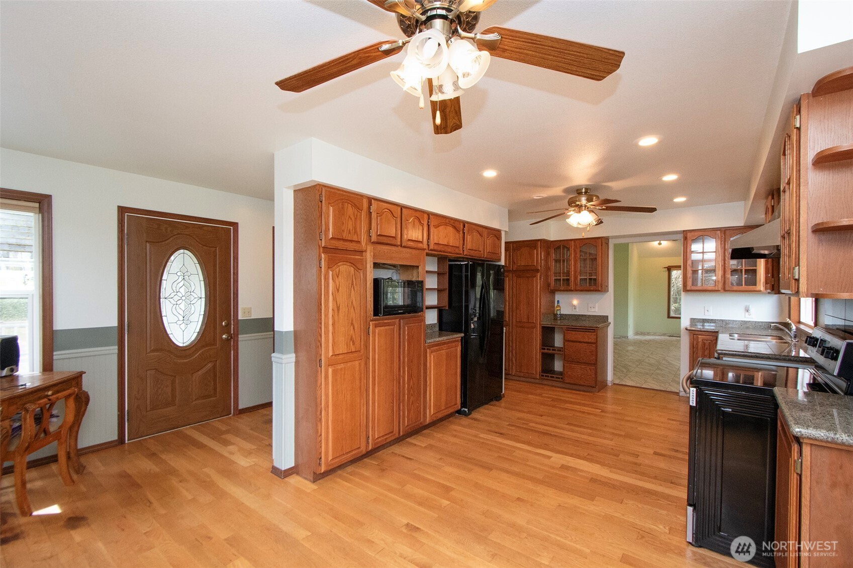 153 Spencer Road Sequim, WA 98382 - Photo 8 of 36 a view of a kitchen with a refrigerator a stove top oven a sink and dishwasher
