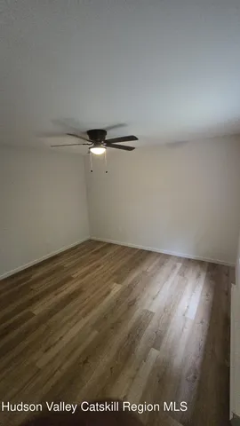 an empty room with wooden floor