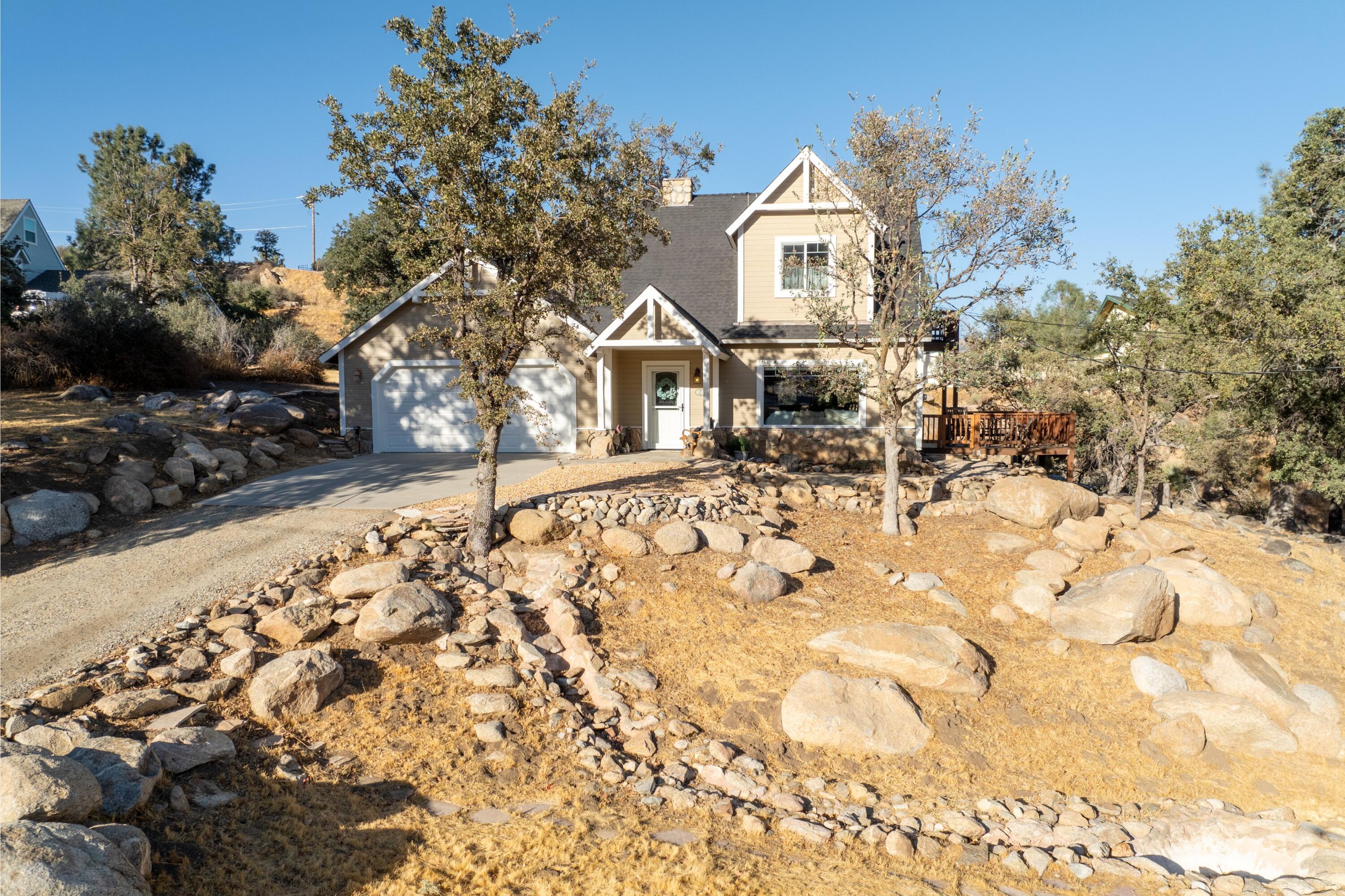 21605 Quail Springs Road Tehachapi, CA 93561 - Photo 1 of 35 a front view of a house with a yard covered with snow