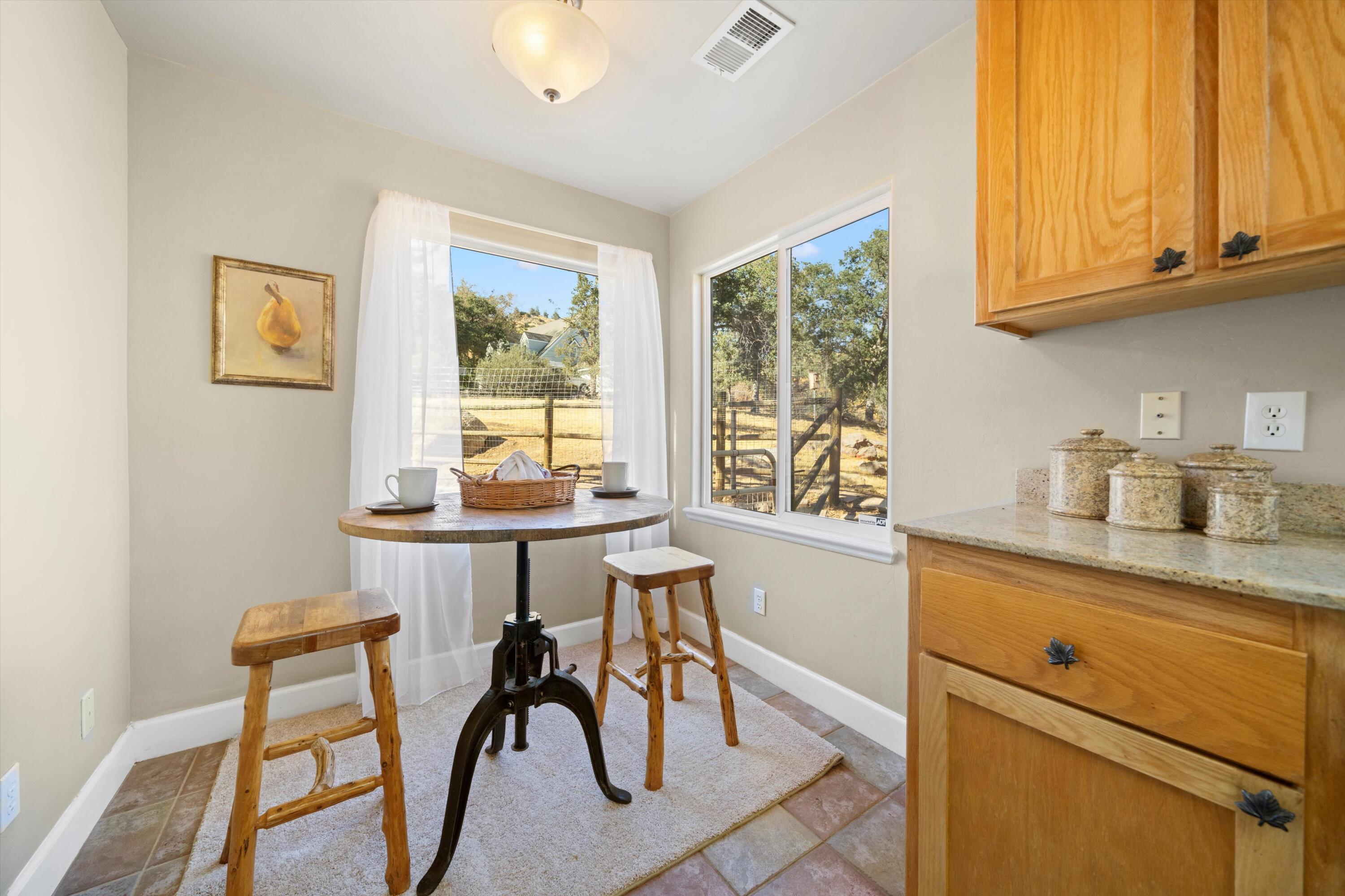 21605 Quail Springs Road Tehachapi, CA 93561 - Photo 11 of 35 a kitchen with stainless steel appliances granite countertop white cabinets and a window