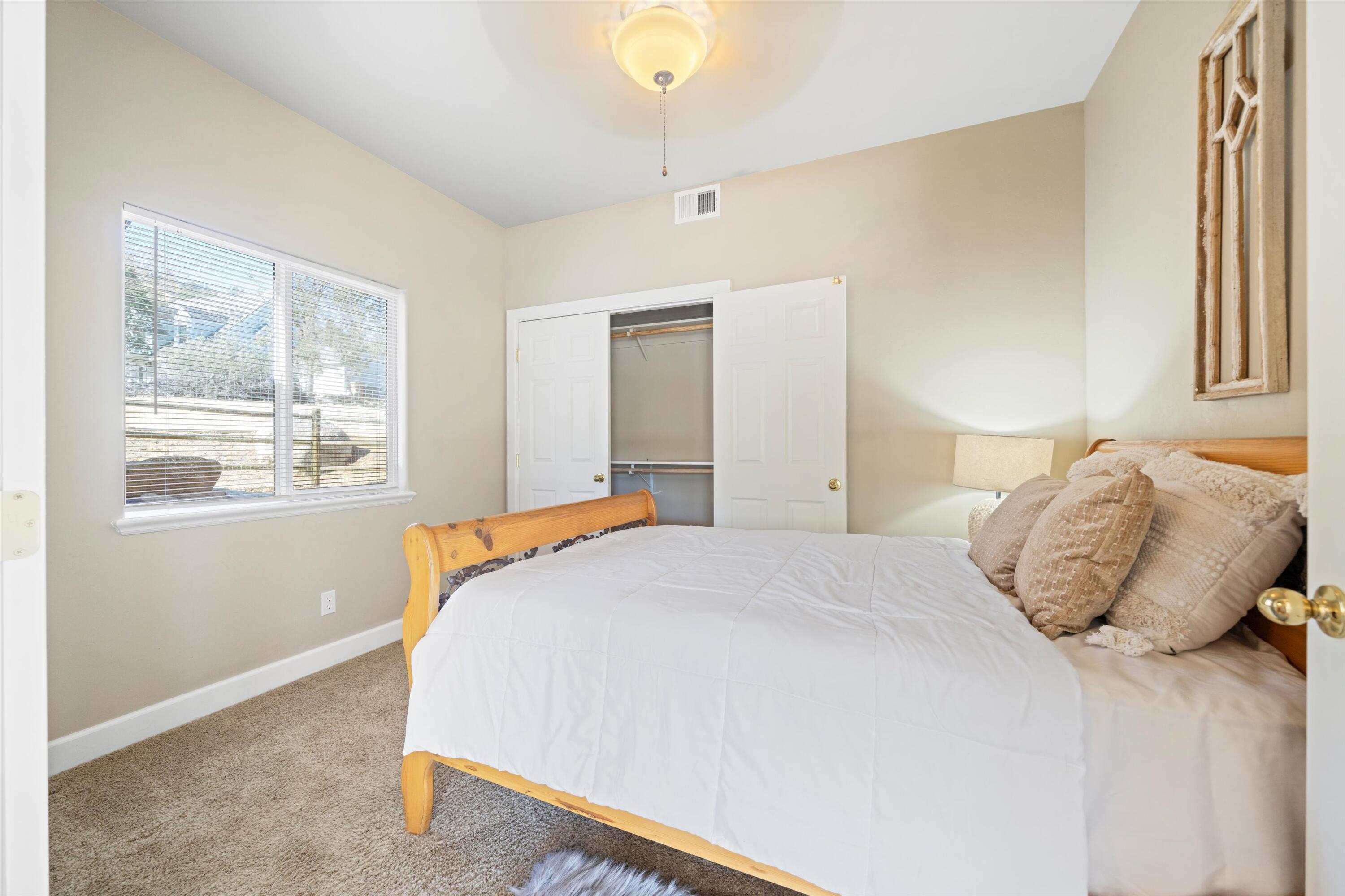 21605 Quail Springs Road Tehachapi, CA 93561 - Photo 13 of 35 a bedroom with a bed and a window