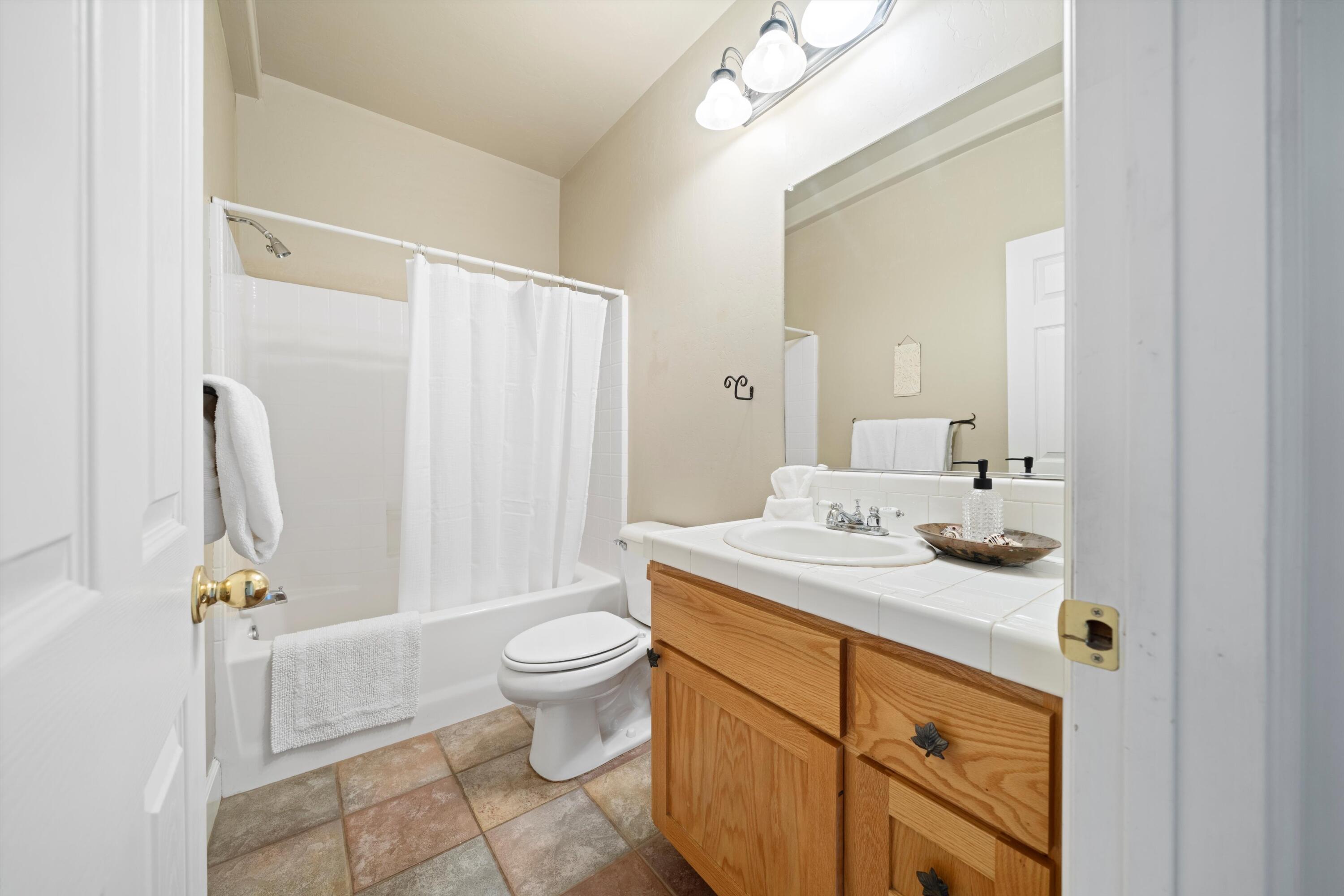 21605 Quail Springs Road Tehachapi, CA 93561 - Photo 14 of 35 a bathroom with a sink toilet and shower
