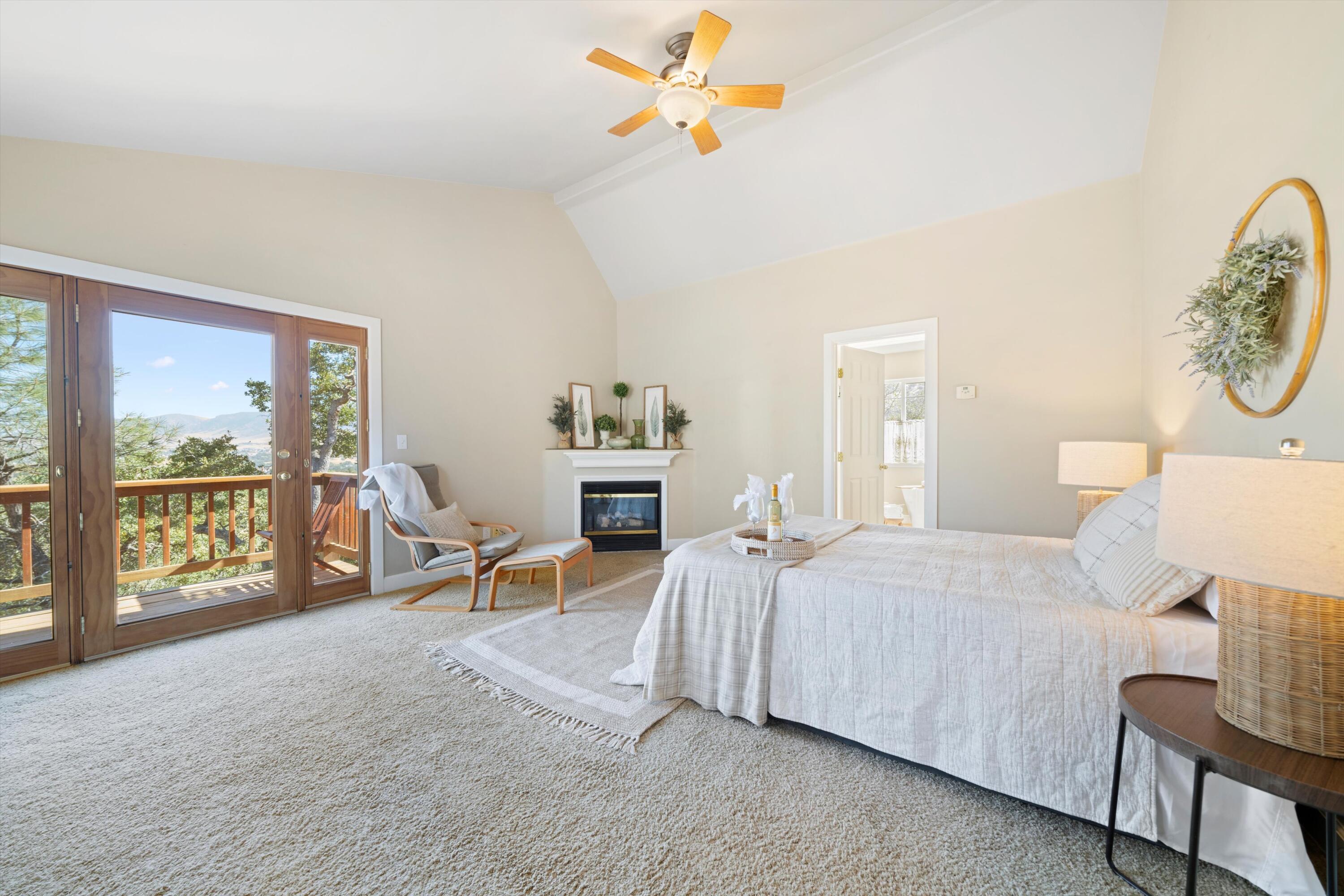 21605 Quail Springs Road Tehachapi, CA 93561 - Photo 15 of 35 a bedroom with a bed a chair and next to a window