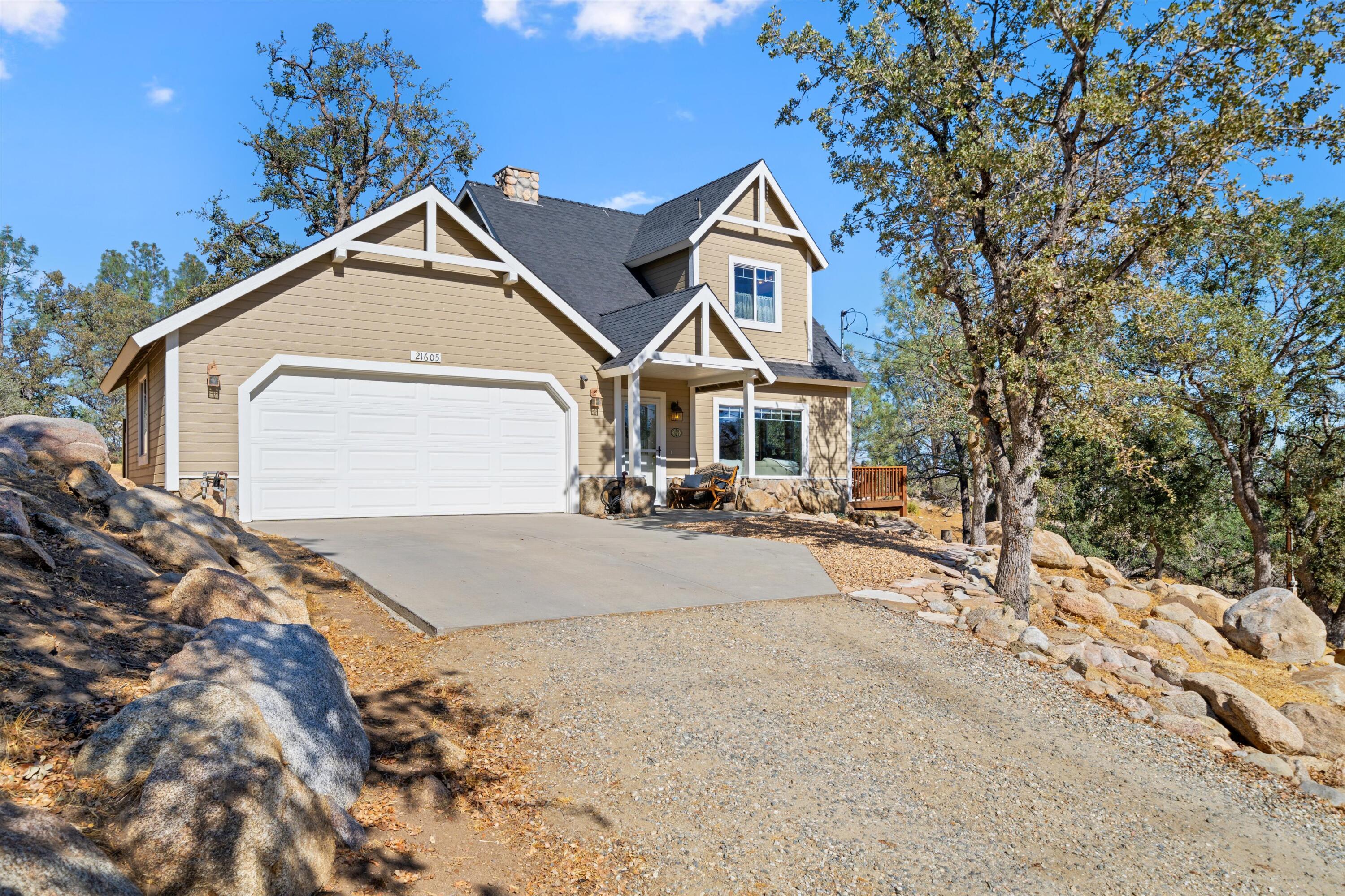 21605 Quail Springs Road Tehachapi, CA 93561 - Photo 2 of 35 a front view of a house with a yard
