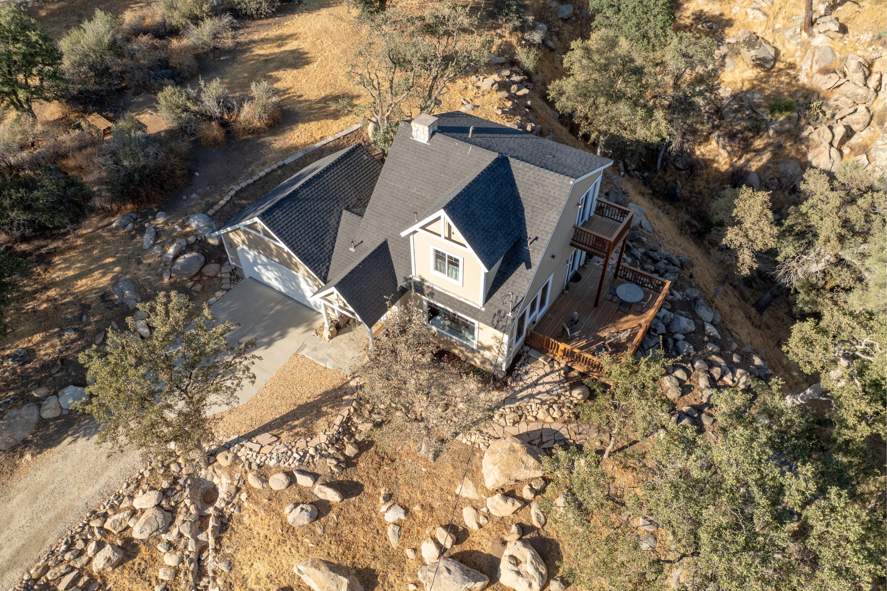 21605 Quail Springs Road Tehachapi, CA 93561 - Photo 28 of 35 a view of a house with a yard and sitting area
