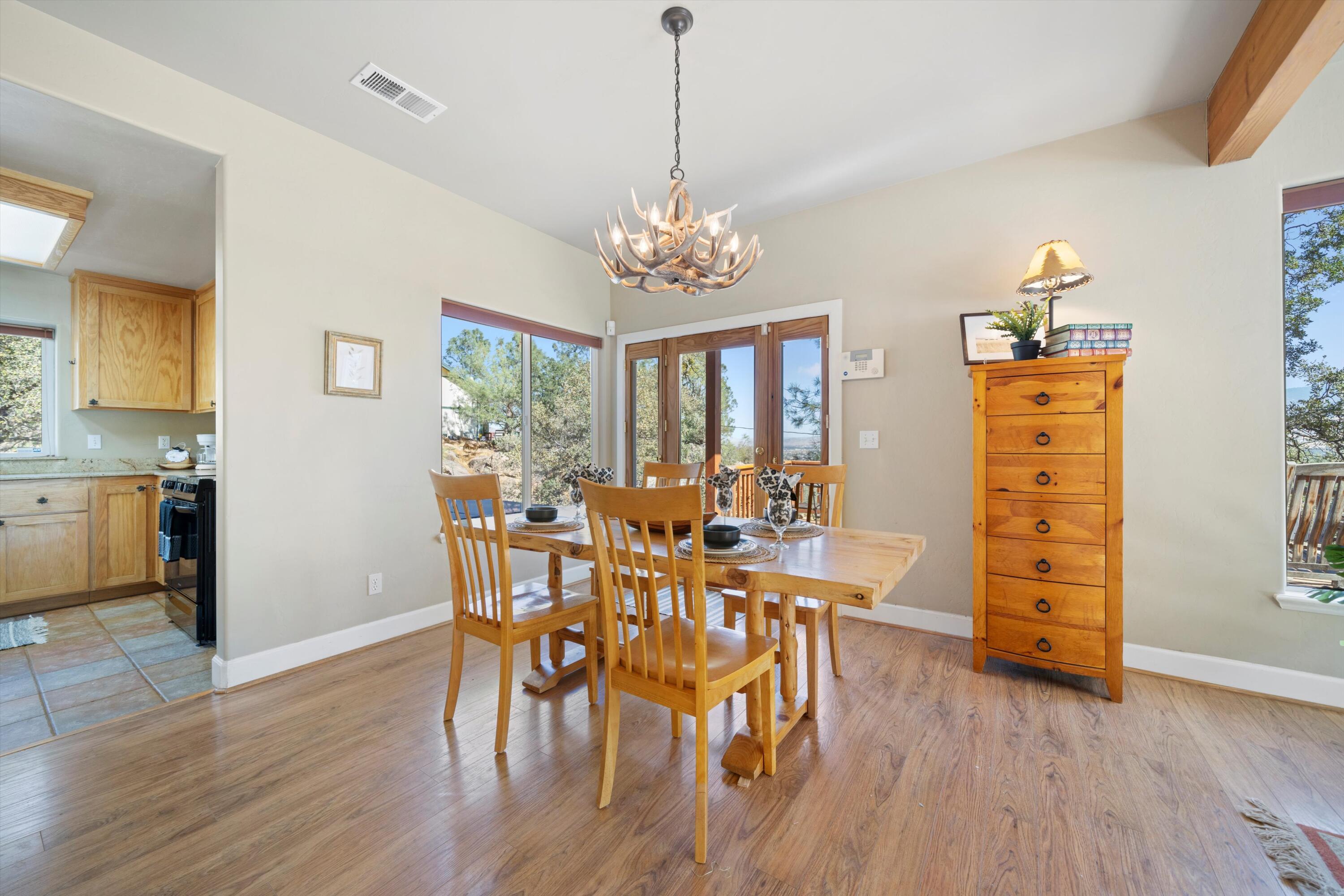 21605 Quail Springs Road Tehachapi, CA 93561 - Photo 7 of 35 a view of a dining room with furniture window and wooden floor