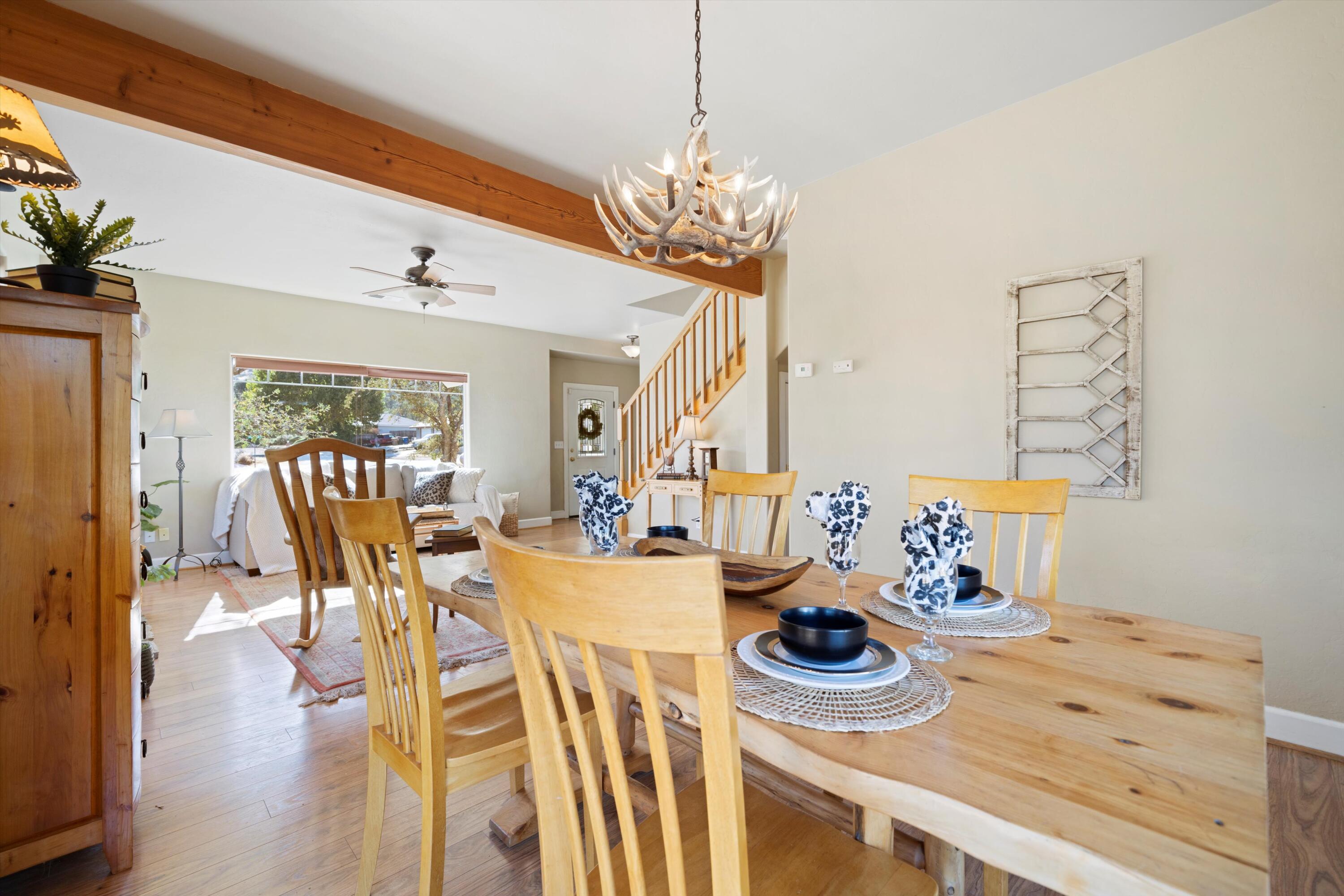 21605 Quail Springs Road Tehachapi, CA 93561 - Photo 8 of 35 a view of a dining room and livingroom with furniture wooden floor a chandelier