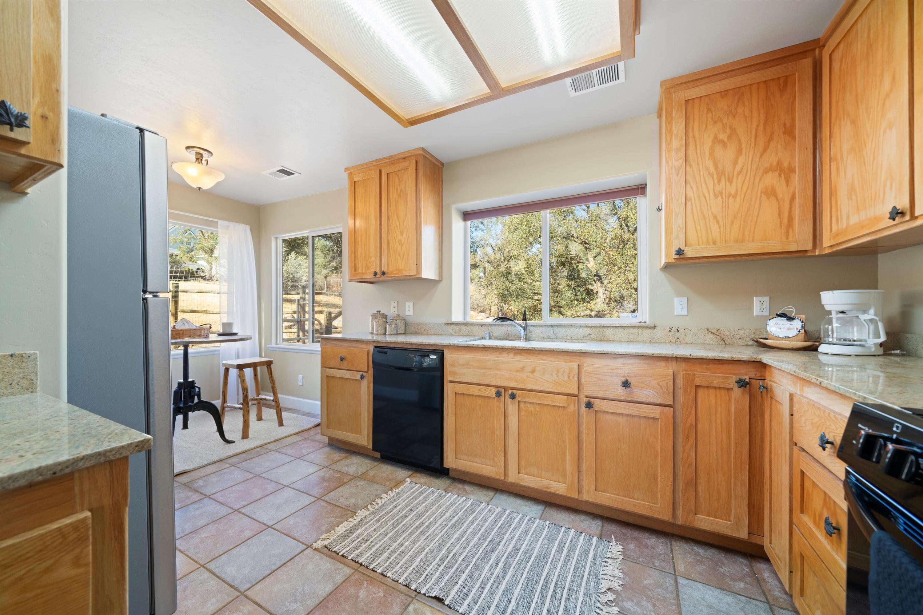 21605 Quail Springs Road Tehachapi, CA 93561 - Photo 9 of 35 a kitchen with granite countertop appliances cabinets and a sink