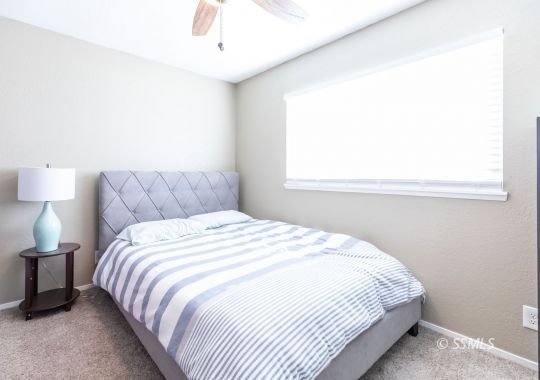 609 South Gemstone Street Ridgecrest, CA 93555 - Photo 20 of 35 a bedroom with a bed and a window