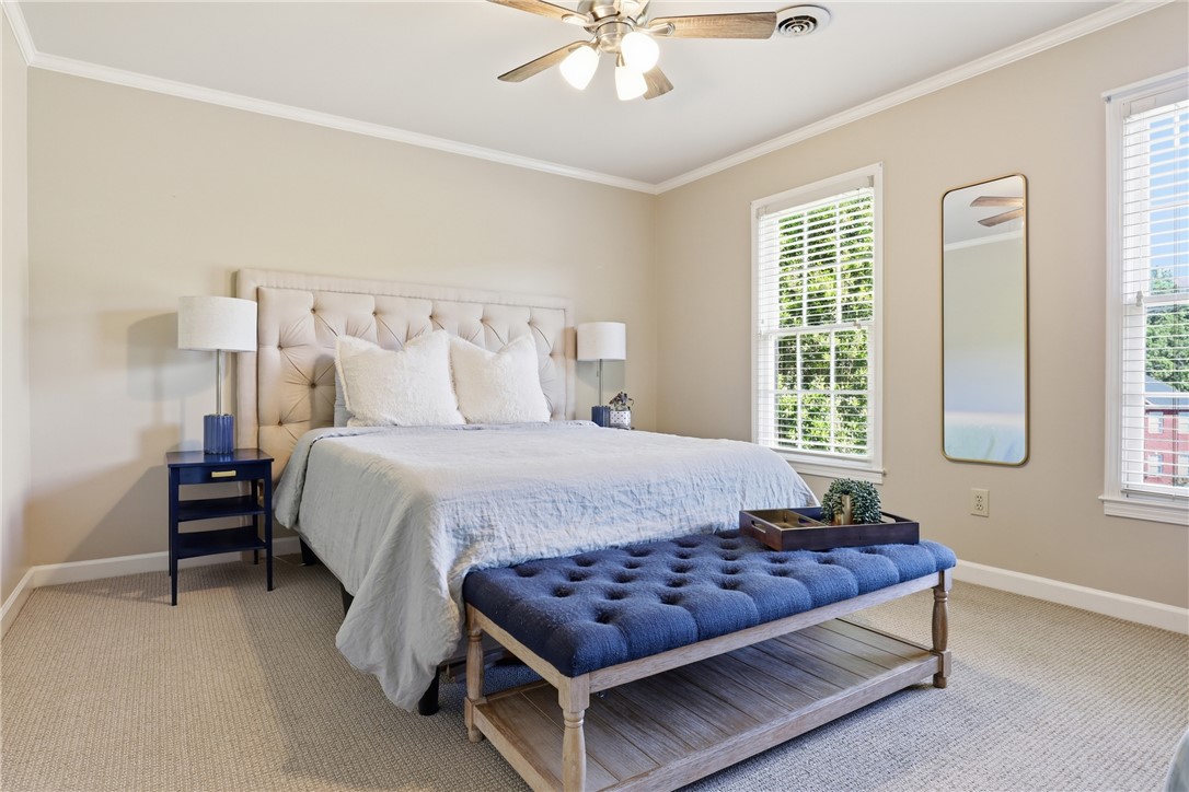 103 5 Knoll Court Anderson, SC 29621 - Photo 17 of 33 Well-lit sleeping quarters with a ceiling fan, plush carpeting, and generous natural light.