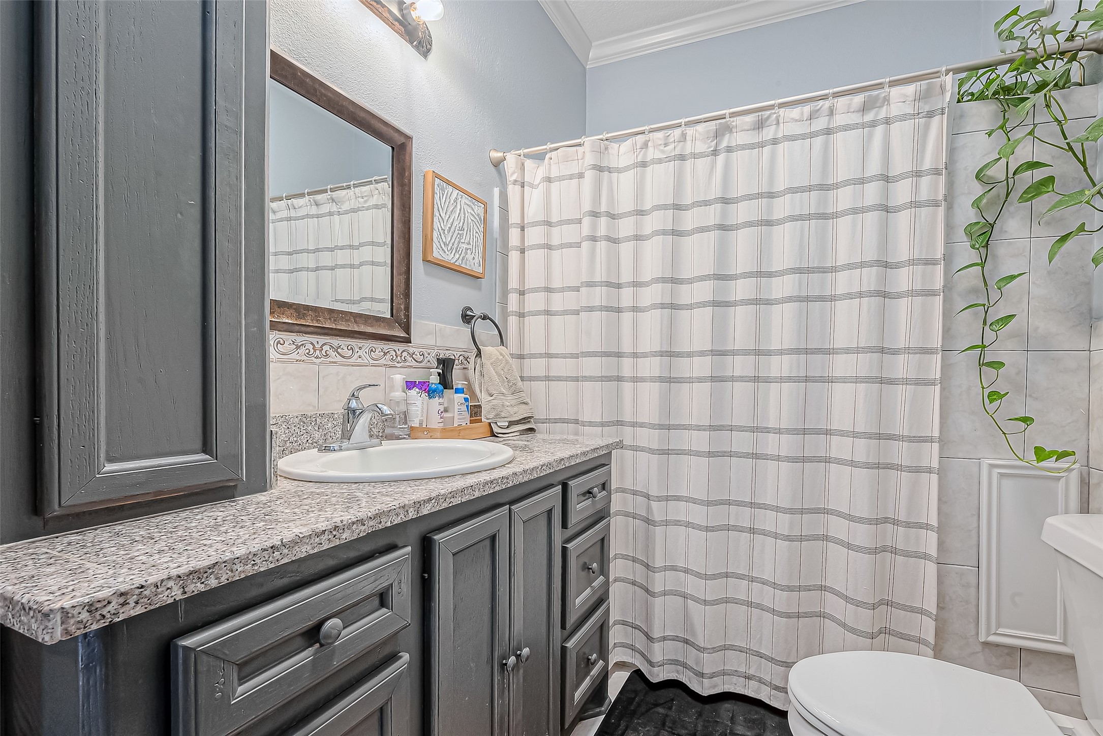 118 Jenkins Street Houston, TX 77003 - Photo 14 of 28 a bathroom with a granite countertop sink and a toilet