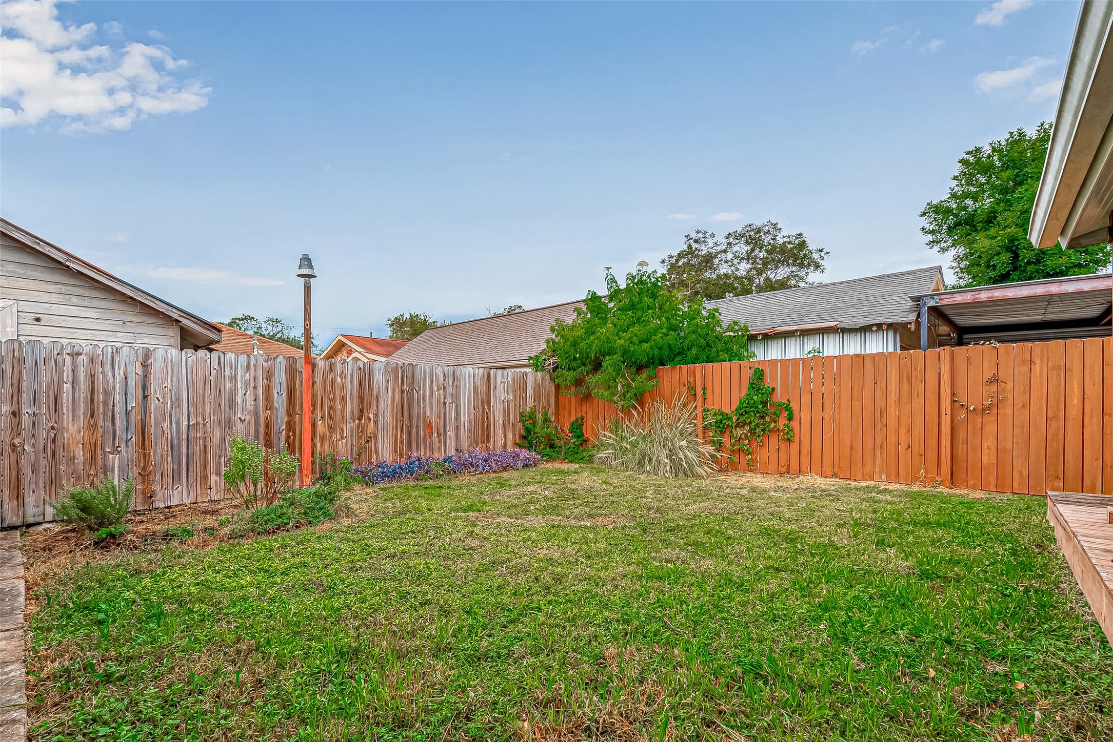 118 Jenkins Street Houston, TX 77003 - Photo 26 of 28 a view of a backyard with potted plants and wooden fence
