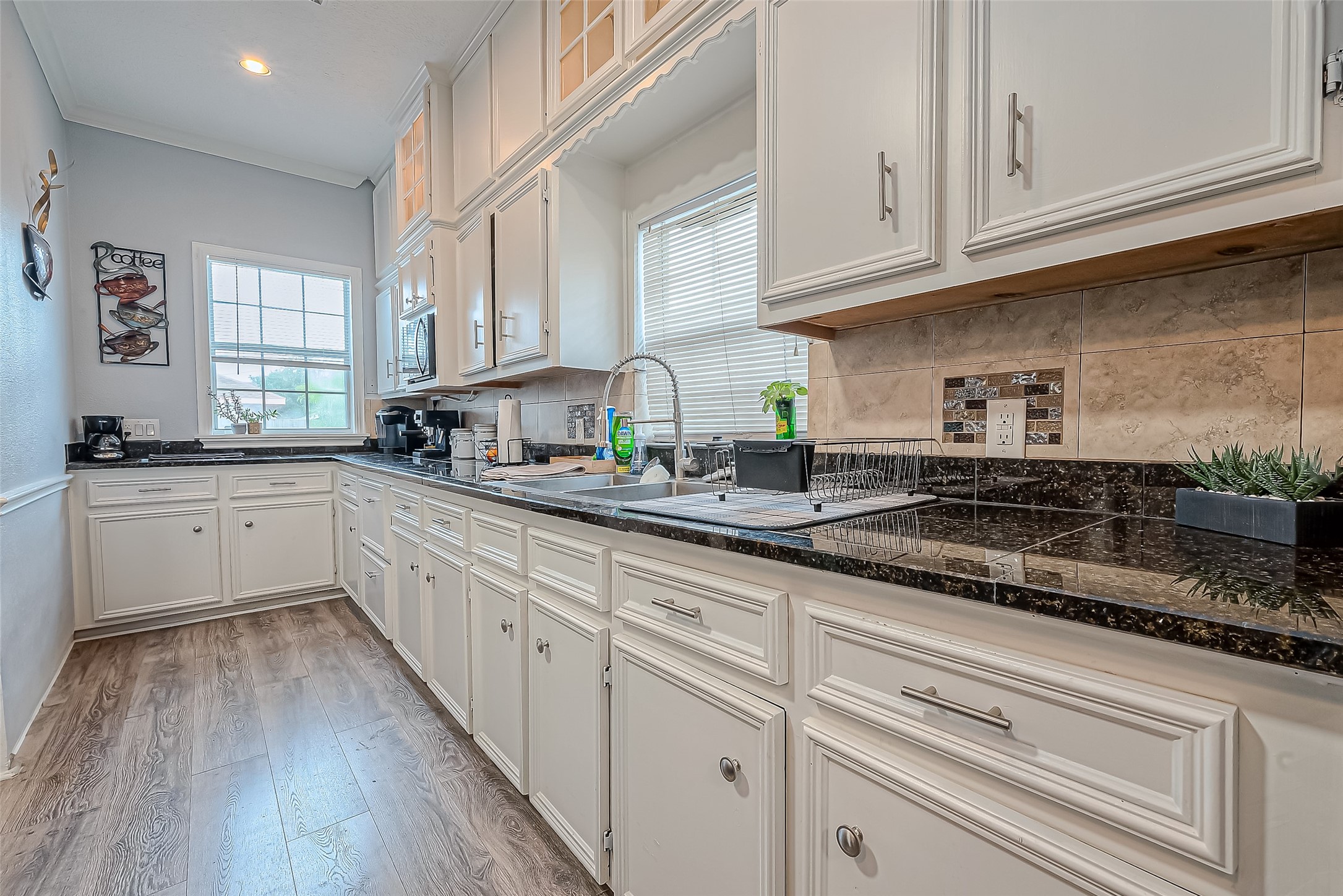118 Jenkins Street Houston, TX 77003 - Photo 9 of 28 a kitchen with granite countertop cabinets stainless steel appliances a sink and dishwasher with wooden floor