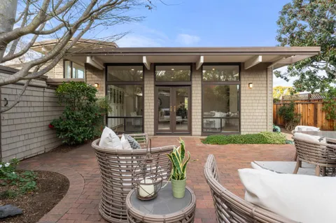 a living room with furniture and view of dining room