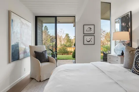 a bathroom with a granite countertop sink a toilet and a mirror