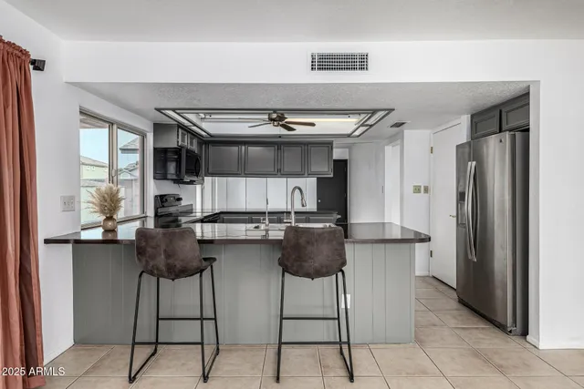 a kitchen with stainless steel appliances granite countertop a stove and a sink