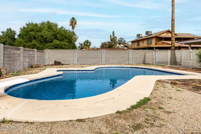 a view of house with swimming pool