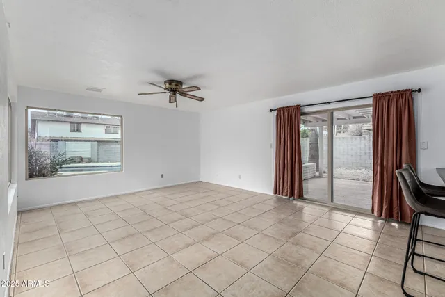a view of a livingroom with furniture and a ceiling fan