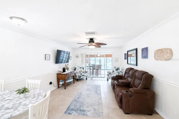 a living room with furniture or couch and a chandelier