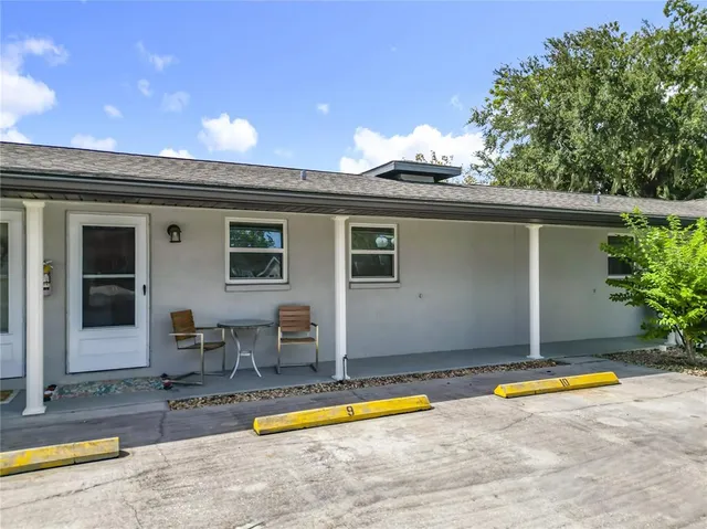 a view of a house with swimming pool and sitting area