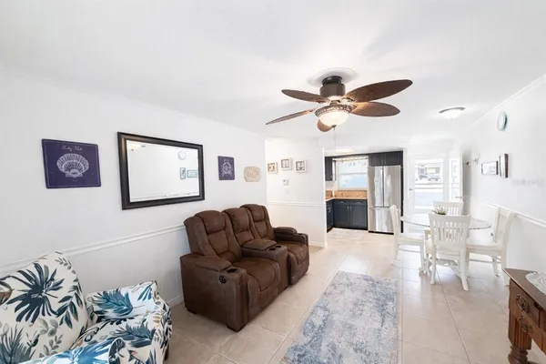 a living room with furniture ceiling fan and a fireplace