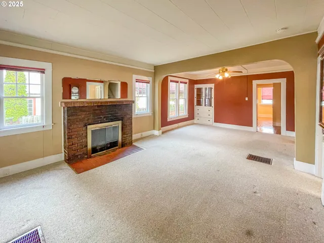 a view of empty room with a fireplace