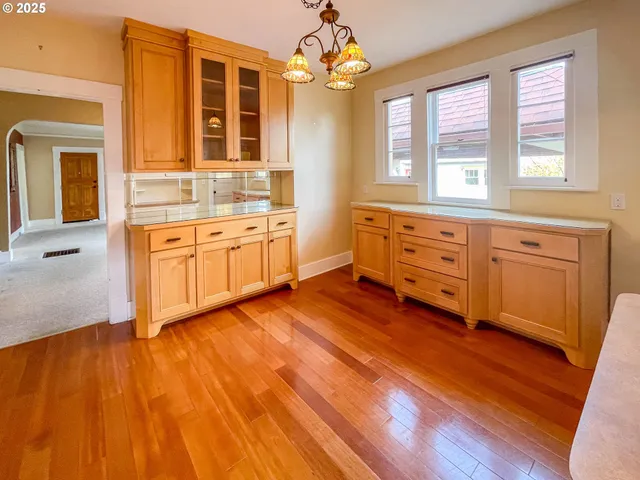 a spacious bathroom with a granite countertop sink mirror and a bathtub