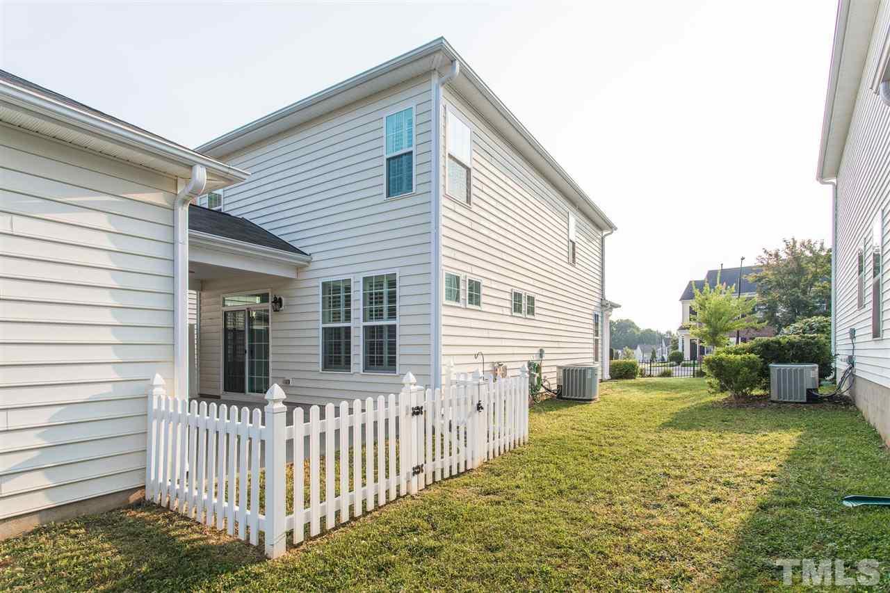1100 Ileagnes Road Raleigh, NC 27603 - Photo 22 of 22 a view of a house with a small yard and wooden fence