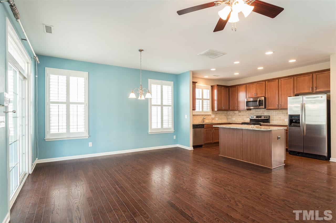 1100 Ileagnes Road Raleigh, NC 27603 - Photo 5 of 22 a kitchen with stainless steel appliances granite countertop a refrigerator a sink dishwasher a stove and white countertops with wooden floor