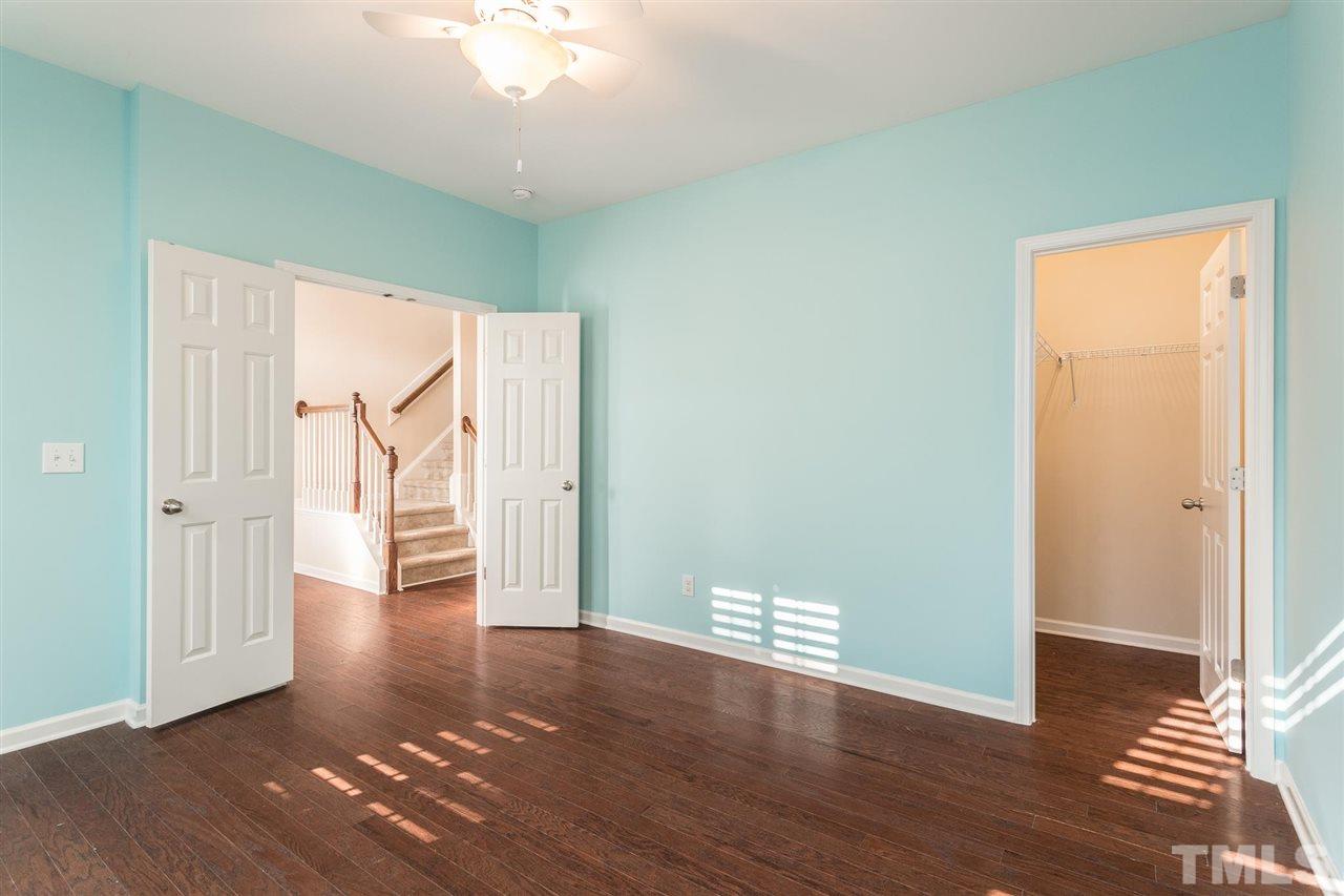 1100 Ileagnes Road Raleigh, NC 27603 - Photo 9 of 22 a view of an empty room with wooden floor and stairs