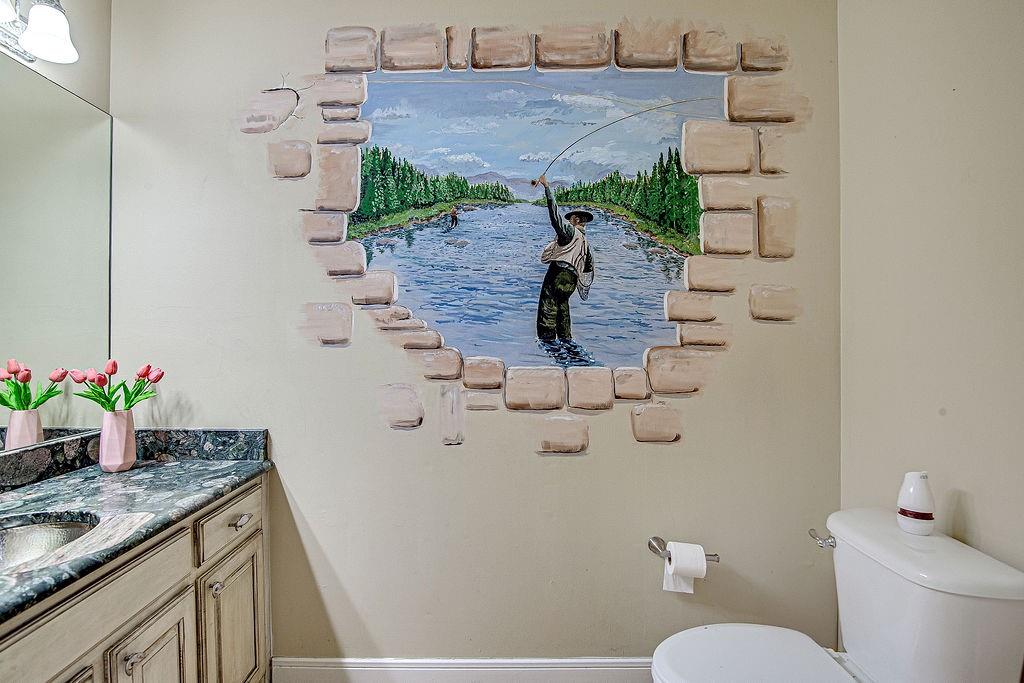 9801 Bellechase Road Granbury, TX 76049 - Photo 12 of 40 a bathroom with a granite countertop sink a toilet and a mirror