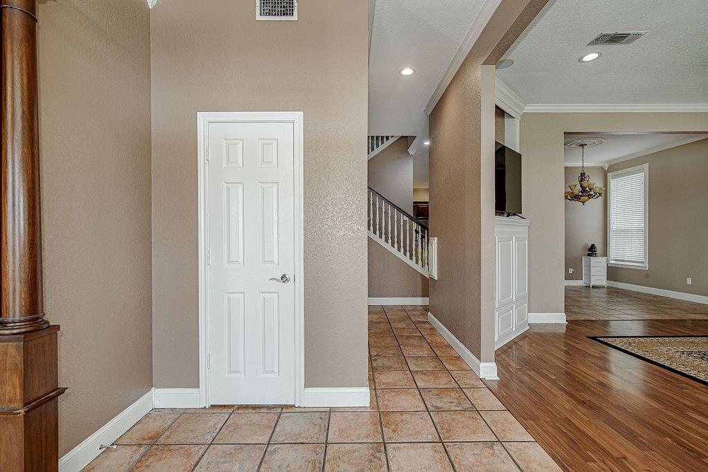 9801 Bellechase Road Granbury, TX 76049 - Photo 17 of 40 a view of a hallway with wooden floor and staircase