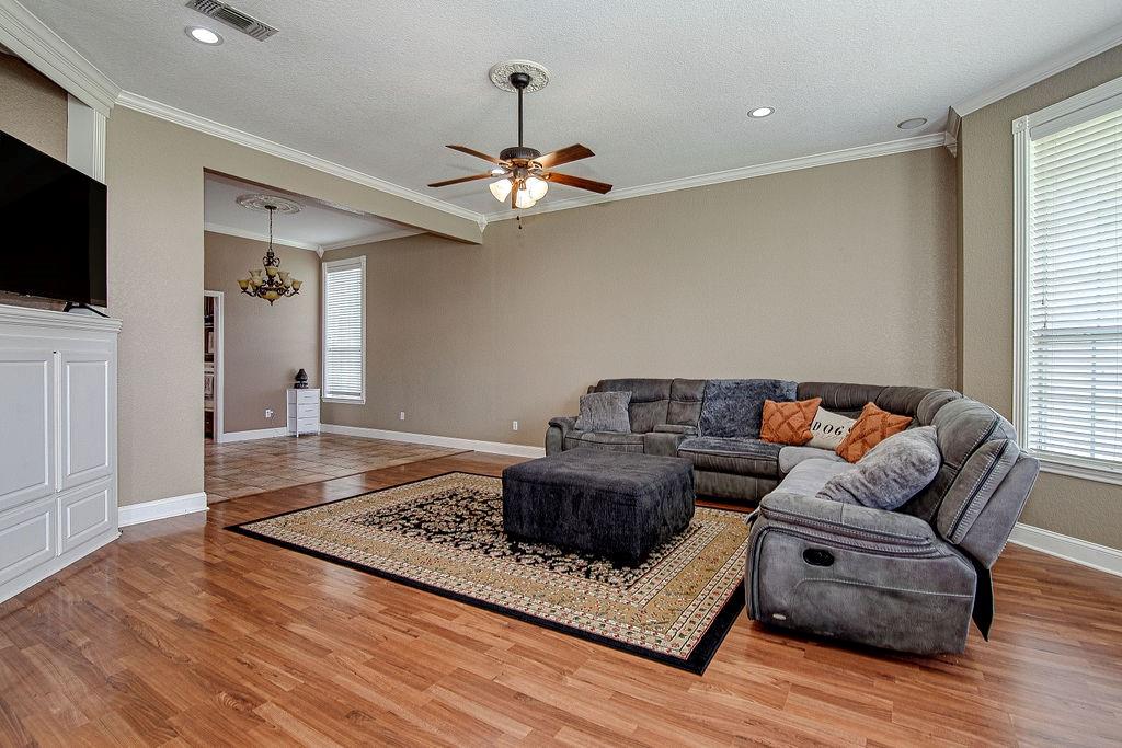 9801 Bellechase Road Granbury, TX 76049 - Photo 20 of 40 a living room with furniture and a flat screen tv