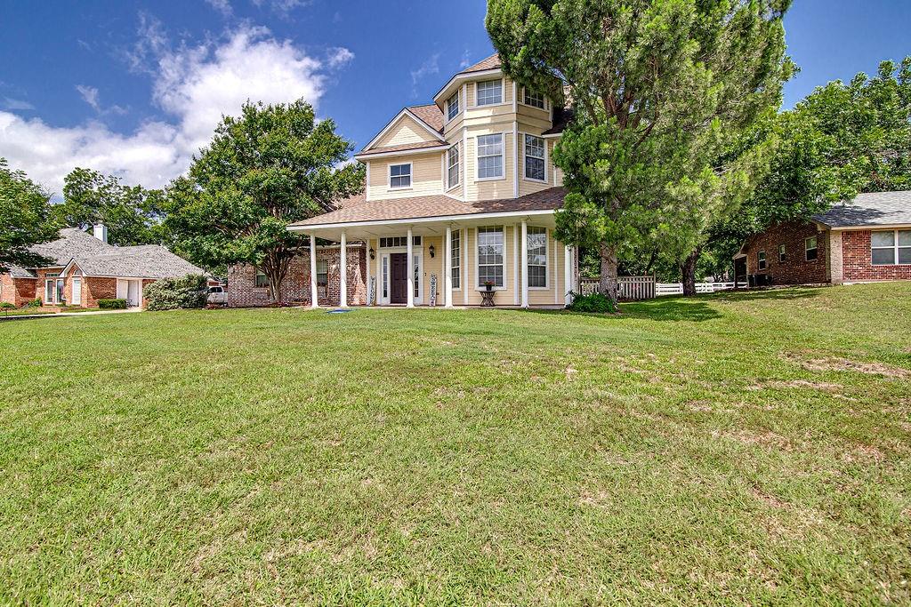 9801 Bellechase Road Granbury, TX 76049 - Photo 2 of 40 a view of a house with a yard and sitting area