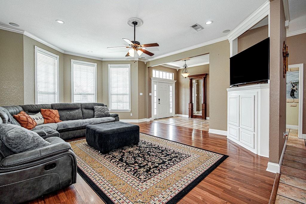 9801 Bellechase Road Granbury, TX 76049 - Photo 21 of 40 a living room with furniture and a flat screen tv