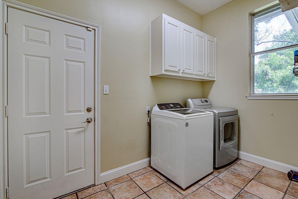 9801 Bellechase Road Granbury, TX 76049 - Photo 22 of 40 a view of storage and utility room with washer and dryer