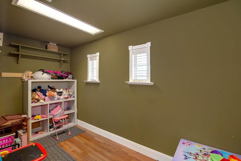 9801 Bellechase Road Granbury, TX 76049 - Photo 23 of 40 a room with toys and a wooden floor