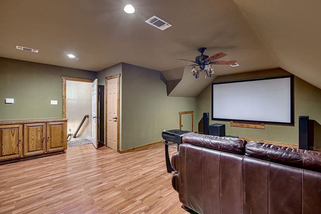 9801 Bellechase Road Granbury, TX 76049 - Photo 27 of 40 a living room with furniture and a wooden floor